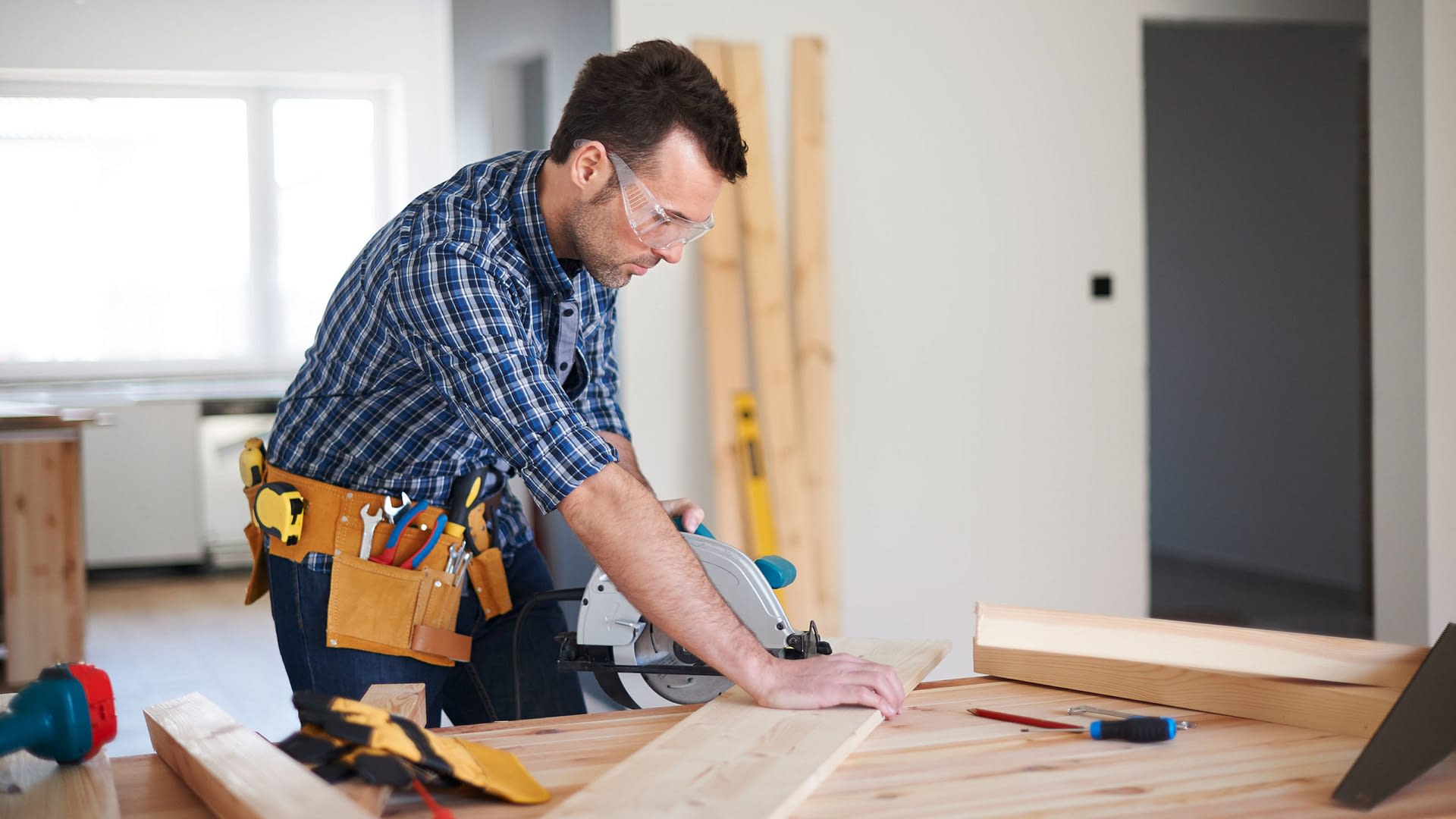 General contractor cutting a board with a circular saw.