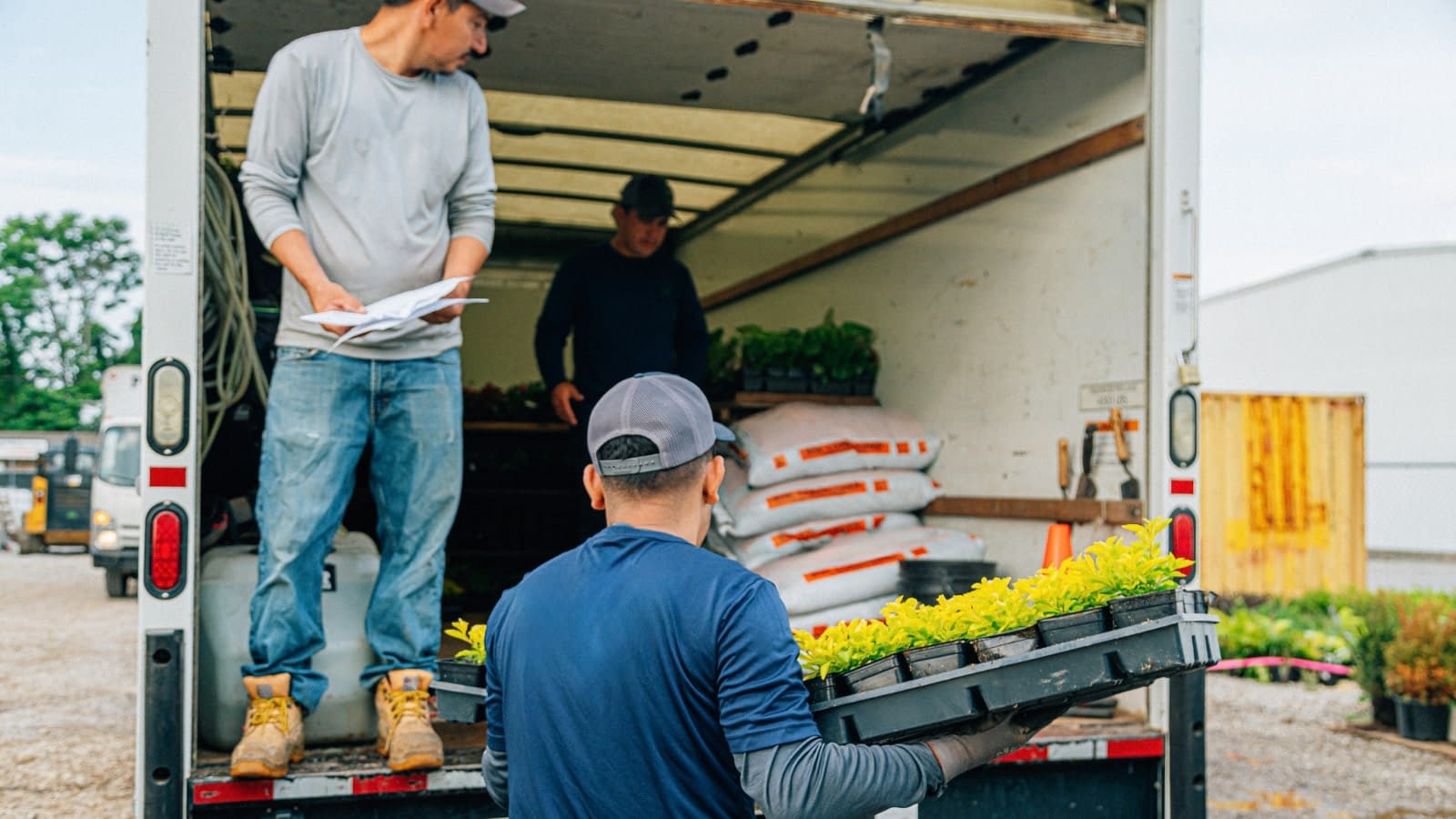 Team of landscapers unloading truck