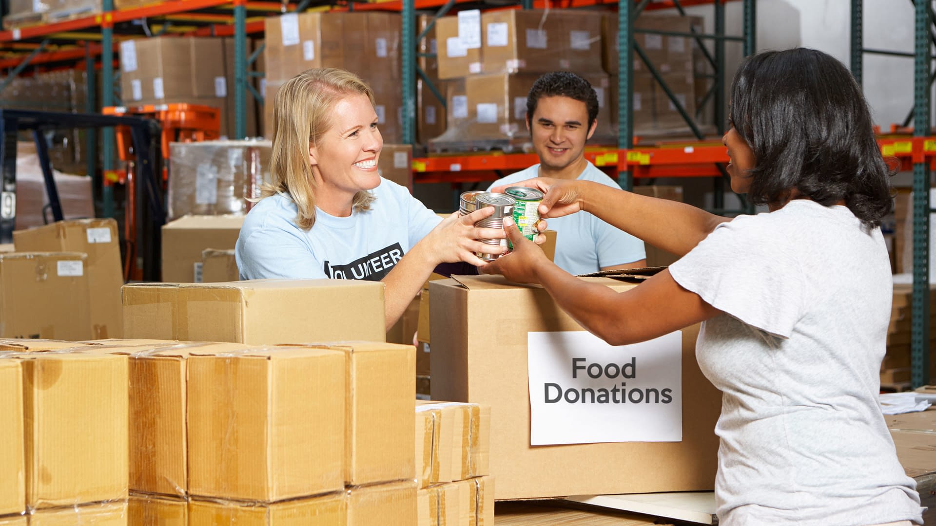 Volunteers accepting donations from a woman.
