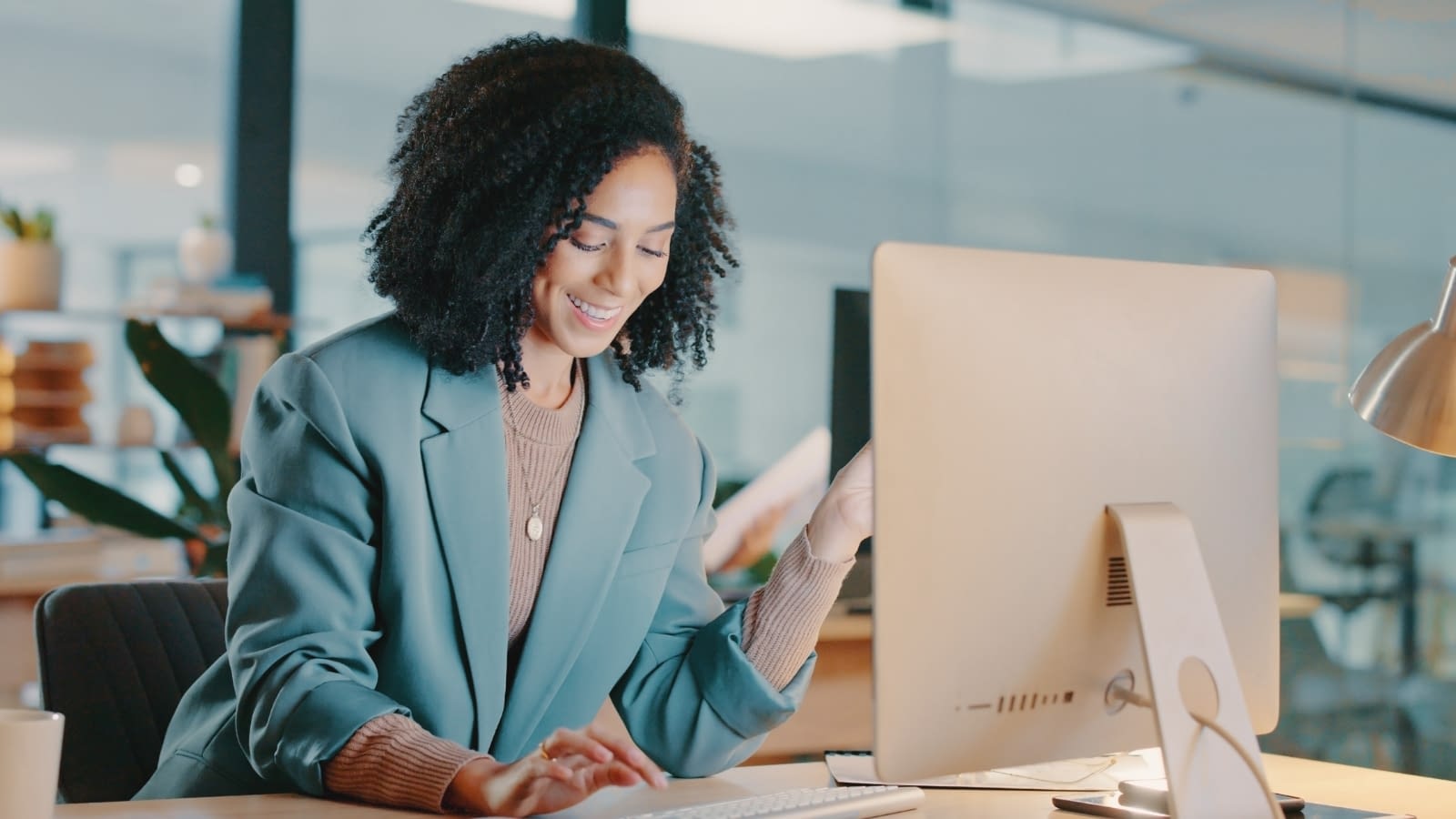 Young female business woman reading laptop
